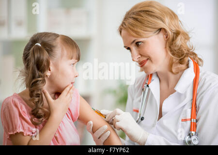 doctor vaccinating frightened preschool child Stock Photo
