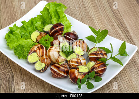 Escargot with parsley butter with salat leaves and mint Stock Photo