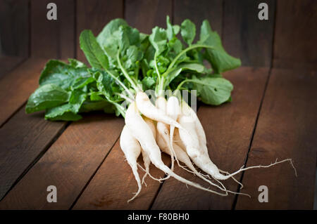 Fresh daikon radish on a wooden background Stock Photo