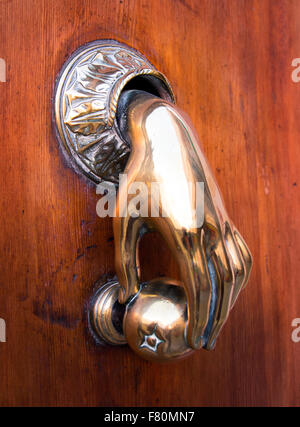 Door knocker in the shape of a hand on an old gate in Valencia, Spain Stock Photo