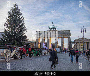 Pariser Platz, Berlin, Germany, 3rd December, 2015. A Christmas tree on Pariser Platz and horses wearing reindeer antlers declare that the festive season has arrived but the display of flowers and candles in front of the French Embassy provides a grim reminder of the recent tragic events in Paris. Credit:  Eden Breitz/Alamy Live News Stock Photo