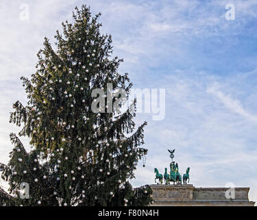 Pariser Platz, Berlin, Germany, 3rd December, 2015. A Christmas tree on Pariser Platz and horses wearing reindeer antlers declare that the festive season has arrived but the display of flowers and candles in front of the French Embassy provides a grim reminder of the recent tragic events in Paris. Credit:  Eden Breitz/Alamy Live News Stock Photo