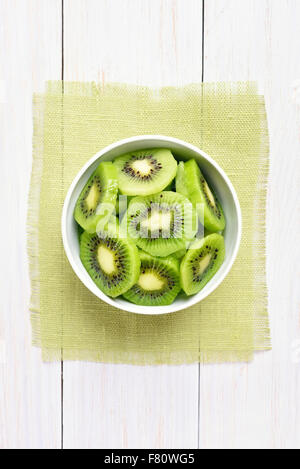 Fruit kiwi slices in bowl, top view Stock Photo