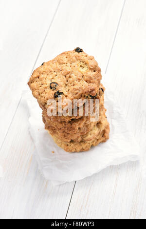 Homemade oats cookies stacked on white background Stock Photo