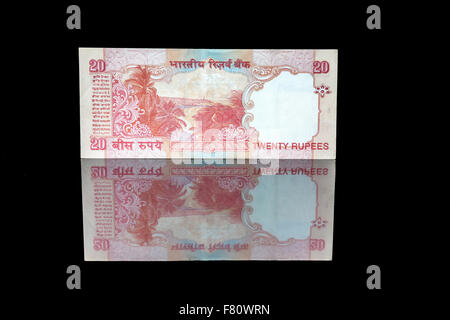 Twenty rupees bill in reflection on black Stock Photo
