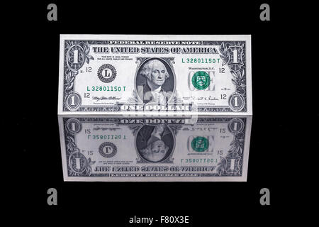 one dollar bill as well as the front and the back with reflection Stock Photo