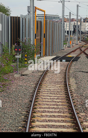 Ground position signal number RD26 showing a red aspect on the exit from depot lines into the station. Stock Photo