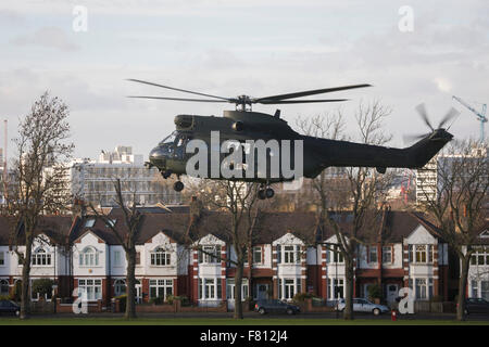 London, UK. 4th December, 2015. A Royal Air Force Puma troop-carrying helicopter lands in Ruskin Park in the south London borough of Lambeth. It is believed that the RAF use various public spaces as part of emergency landing/evacuation location familiarisation in readiness of a future national emergency. Credit:  RichardBaker/Alamy Live News Stock Photo