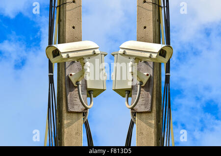 Two closed circuit camera on blue sky background Stock Photo