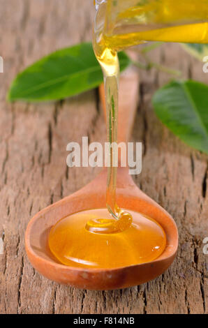 Honey dripping into a jar from wooden spoon Stock Photo - Alamy