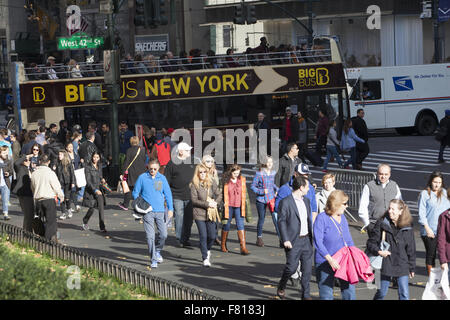 Crowds of tourists and shoppers cross 42nd St. at 5th Ave. on Black Friday the official start of the holiday shopping season NYC Stock Photo