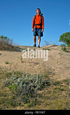 WA12220-00...WASHINGTON - Hiker on a cross country walk at Juniper Dunes Wilderness area heading north towards the larger dunes. Stock Photo