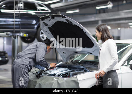 Auto mechanic and car owner Stock Photo