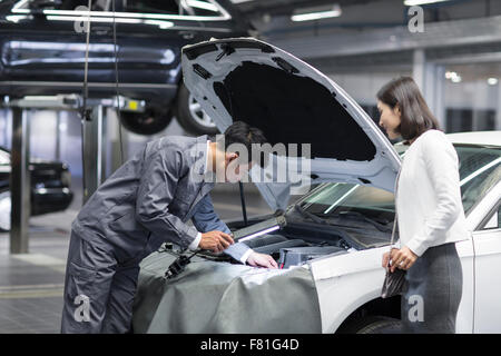 Auto mechanic and car owner Stock Photo