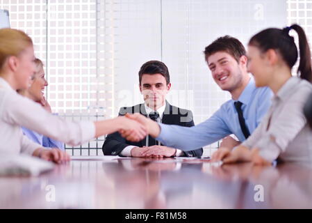 business people shaking hands make deal and sign contract in bright modern office Stock Photo