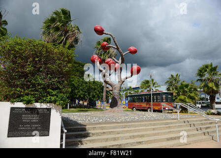 Trolley and sculpture (by the artist Ming Fay) at the center of the town of Yauco, Puerto Rico. USA territory. Caribbean Island. Stock Photo