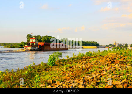 Tugboat pushing barges along the great Mississippi river seen here at Greenville MS Stock Photo