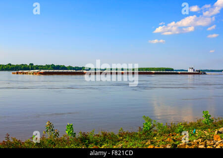 Tugboat pushing barges along the great Mississippi river seen here at Greenville MS Stock Photo