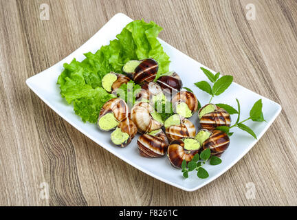 Escargot with parsley butter with salat leaves and mint Stock Photo