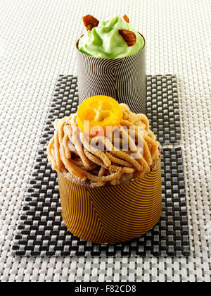 Artisan Patissier of thin chocolate cases filled with chestnut puree and mint mousse Stock Photo
