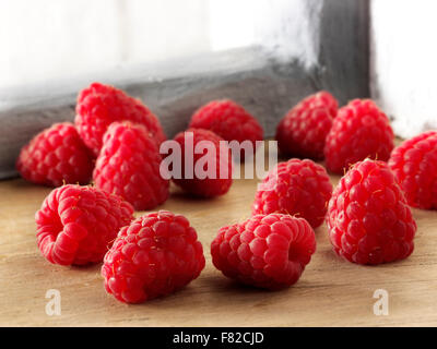 Close up of fresh whole red raspberry fruits in a kitchen setting Stock Photo