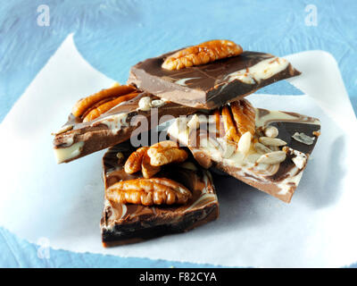 milk and white chocolate slabs pieces with pecan nuts Stock Photo
