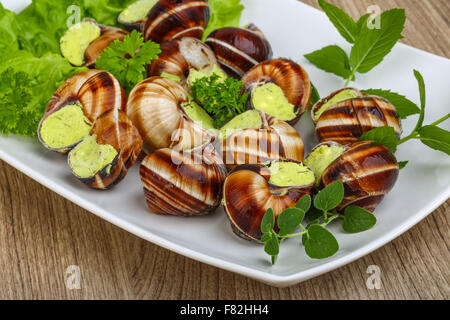 Escargot with parsley butter with salat leaves and mint Stock Photo