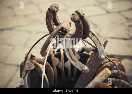 Large group of old steel rusted horseshoes, vintage tonal correction filter, old style photo Stock Photo