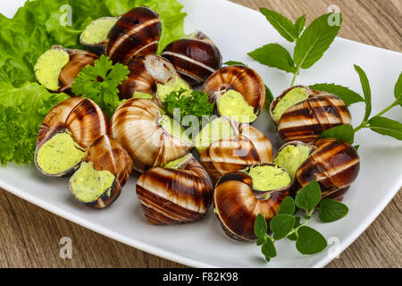 Escargot with parsley butter with salat leaves and mint Stock Photo