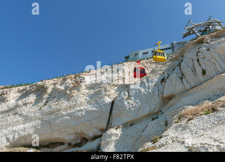 funicular with yellow and red cabin on white background rock Stock Photo