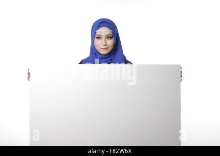 Malaysian asian malay woman holding an empty white board for content space isolated in white Stock Photo