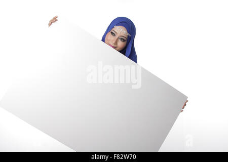 Malaysian asian malay woman holding an empty white board for content space isolated in white Stock Photo