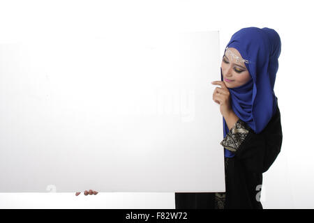 Malaysian asian malay woman holding an empty white board for content space isolated in white