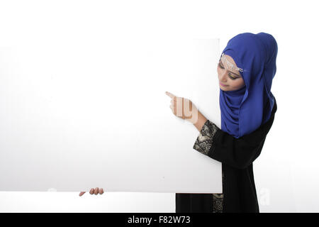 Malaysian asian malay woman holding an empty white board for content space isolated in white Stock Photo