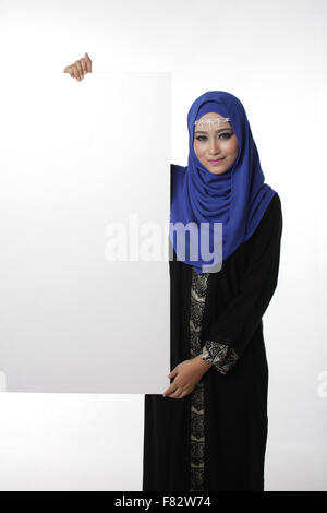 Malaysian asian malay woman holding an empty white board for content space isolated in white Stock Photo