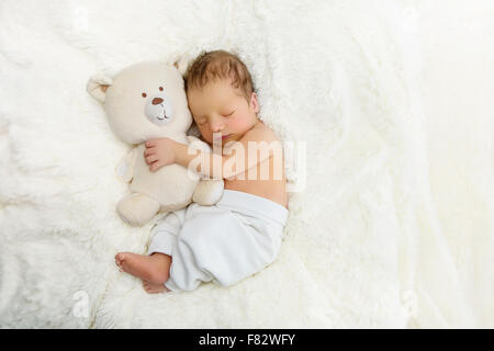 Newborn with toy bear Stock Photo