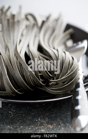 black uncooked noodles with squid sepia ink Stock Photo