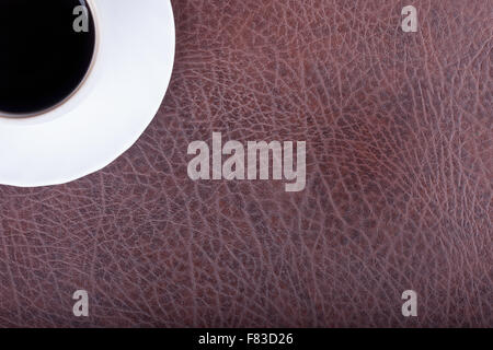 cup of coffee on a leather textured surface Stock Photo