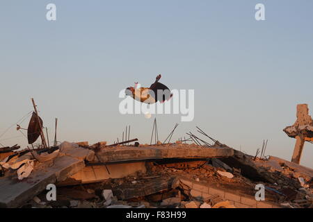 Gaza, Palestine. 05th Dec, 2015. Palestinian youths practicing Parkour skills on the ruins of the houses that were destroyed during the Israeli attack at the east of Khan Yunis in the southern Gaza Strip. Credit:  Ramadan El-Agha/Pacific Press/Alamy Live News Stock Photo