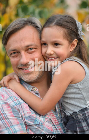 beautiful mom and daughter outdoor in garden together with flower have ...