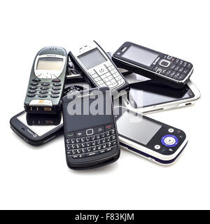 A Collection Of Old Mobile Cell Phones on A White Background Stock Photo