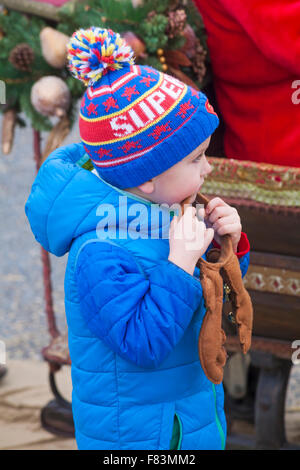 Bournemouth, Dorset, UK, 5th Dec, 2015. Young boy holding reindeer antler bands looking at Father Christmas, aka Santa Claus, at Boscombe Pier for the parade into Boscombe centre. Credit:  Carolyn Jenkins/Alamy Live News