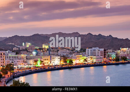 Dusk view of the Mutrah corniche and surrounding mountains in Muscat, the capital of the Sultanate of Oman. Stock Photo