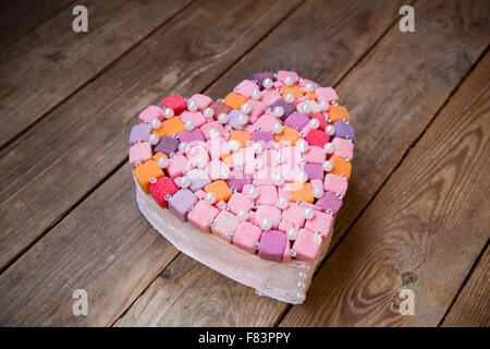 handmade  multicolored heart with decorative material on wooden background Stock Photo