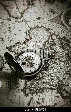 Vintage antique pocket watch on old map background, close up Stock Photo