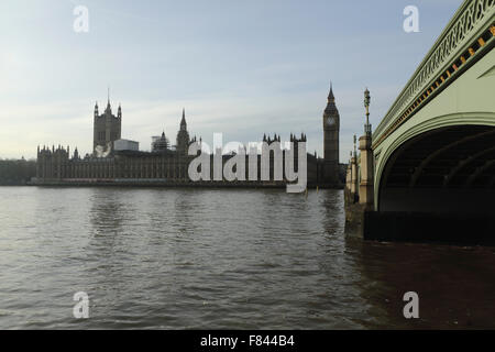 Westminster Bridge crosses the River Thames by the Houses of Parliament in London, UK. A haze envelops the Palace of Westminster Stock Photo