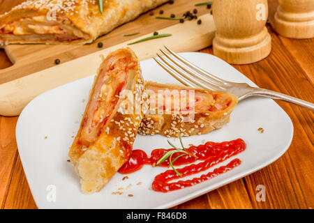 Puff pastry roll with cheese and ham Stock Photo