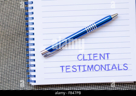 Client testimonials text concept write on notebook with pen Stock Photo