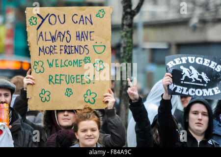 Belfast, Northern Ireland. 05 Dec 2015 - Pro-refugee supporter holds up a sign saying 'you can always have more friends. Welcome Refugees!' at a protest rally. Credit:  Stephen Barnes/Alamy Live News Stock Photo