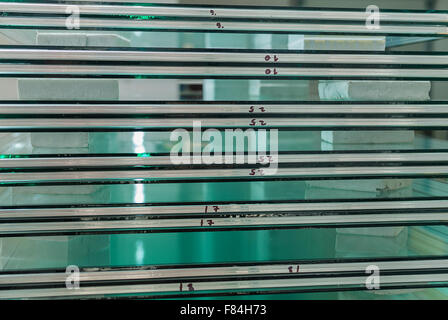 Sheets of Factory manufacturing tempered clear float glass panels cut to size Stock Photo